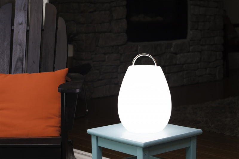 Nomad lantern glowing white on table