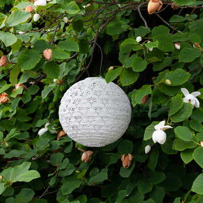 Soji Stella Deco Globe Tyvek Solar Lantern in garden