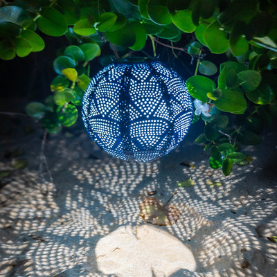 Soji Stella 8" Globe Tyvek Solar Lantern glowing in Hawaii