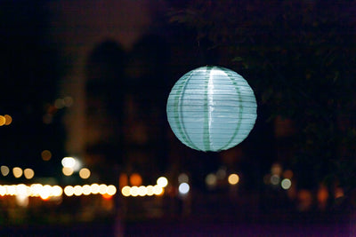 Sage Green Festival Solar Lantern glowing at night
