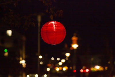 Warm Red Festival Solar Lantern glowing at night