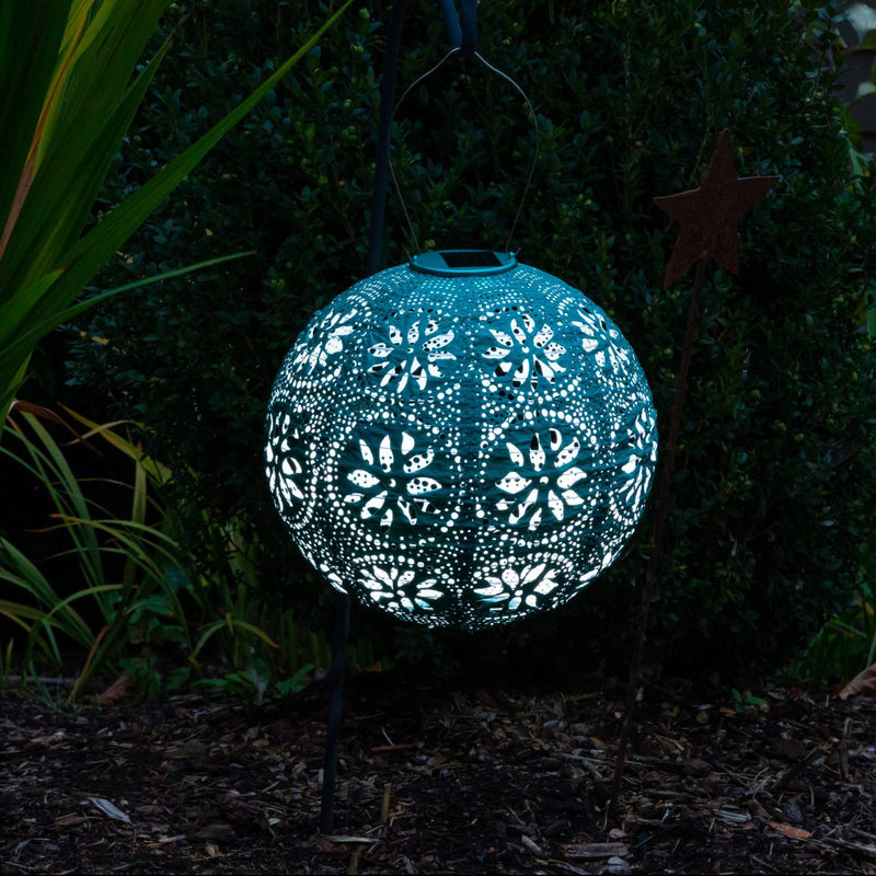 Soji Stella Boho Tyvek Solar Lantern glowing in garden