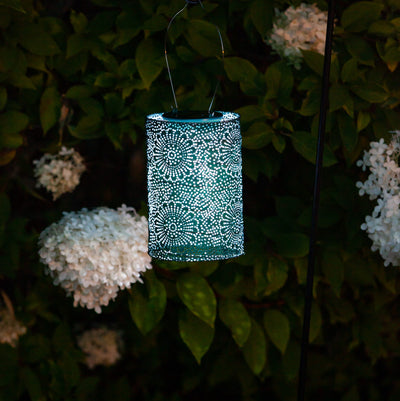 Soji Stella Cylinder Tyvek Solar Lantern glowing in garden
