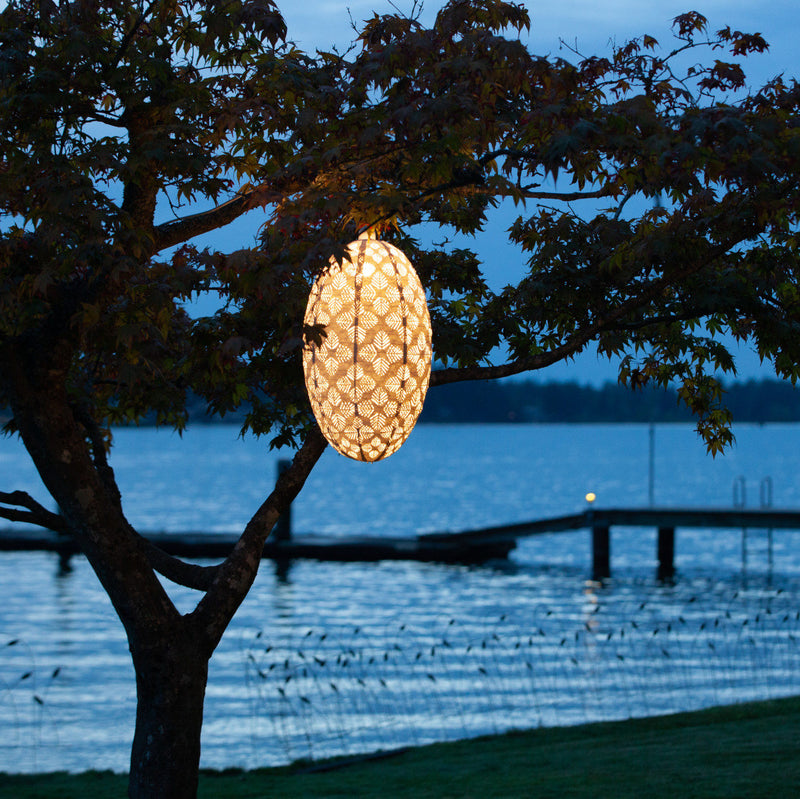 Soji Stella Nova Palm Pod Indoor Outdoor Tyvek Pendant Lamp in tree