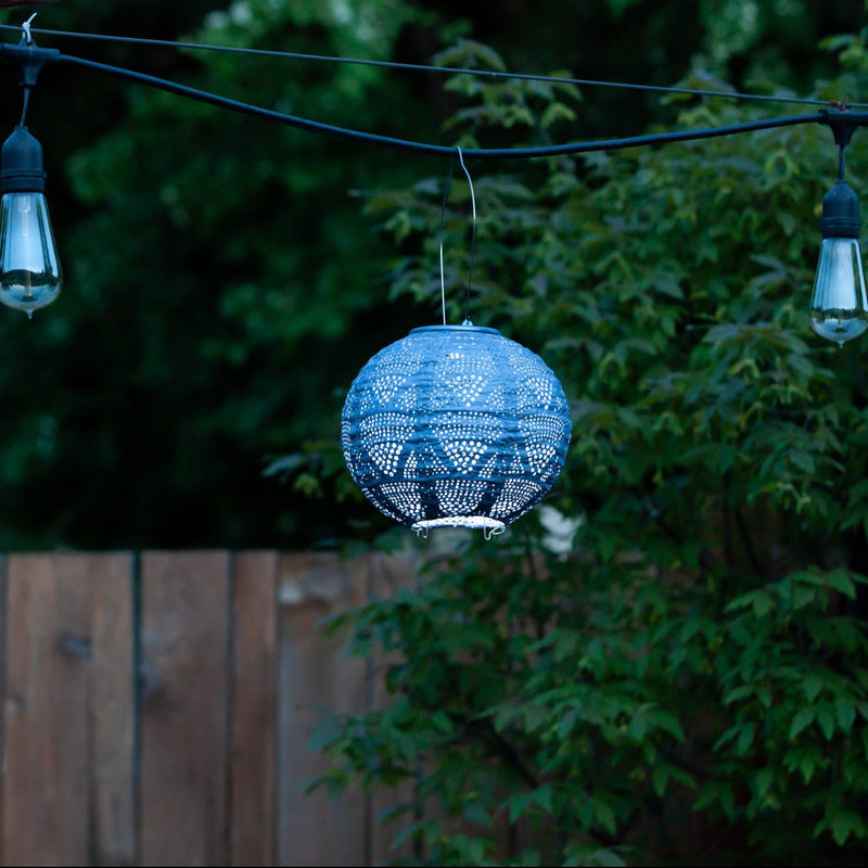 Soji Stella 8" Globe Tyvek Solar Lantern hanging from string lights